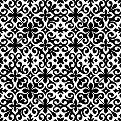 Seamless black and white ornamental pattern with floral and swirl motifs. Elegant decorative background for tiles, textiles, or wallpaper.