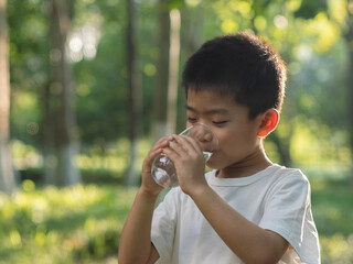 Chinese children drinking water outdoors in summer

