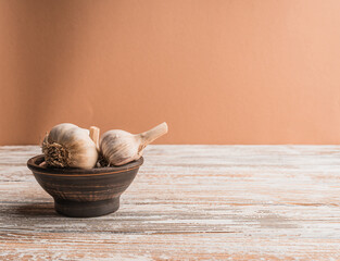 Garlic bulbs on a wooden table with copy space.