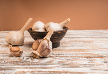 Garlic bulbs on a wooden table with copy space.