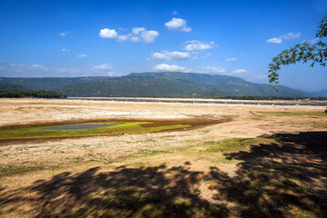 Expansive Landscape with Mountains and a Sunny Blue Sky