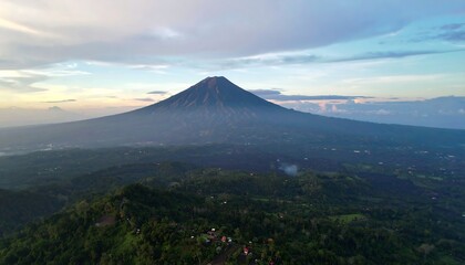 Volcano with lush green landscape at sunrise/sunset