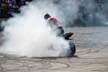 Stunt driver do tire burnout with his motorbike on motorfest in Banja Luka, adrenaline action