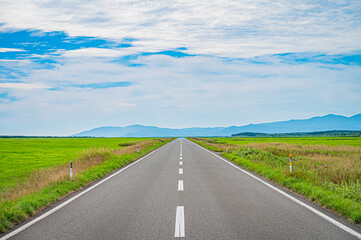 Endless straight road at Esanuka Line, Hokkaido countryside, Japan