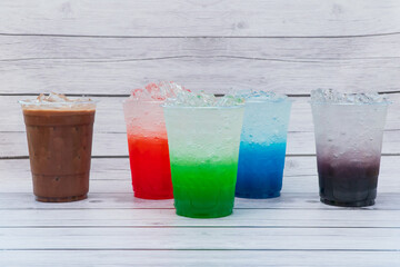 Ice drink with sweet, bright colors, put in a clear plastic glass.