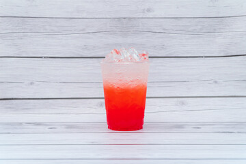 Ice drink with sweet, bright colors, put in a clear plastic glass.