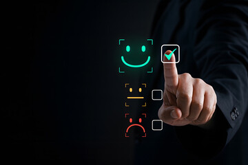 Customer Satisfaction: A close-up shot of a hand selecting a smiley face in a customer satisfaction survey.