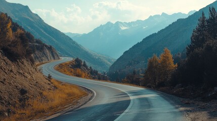 Fototapeta premium Winding mountain road leading to distant peaks showcasing scenic travel and adventure