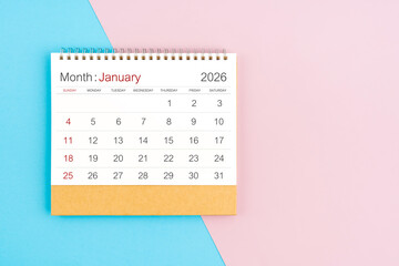 January 2026 desk calendar on blue and pink color background, with copy space.