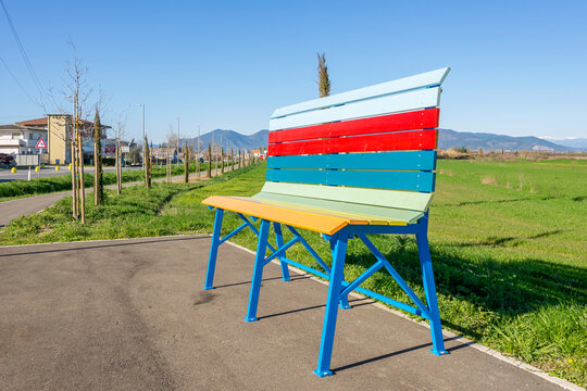 A colorful giant bench at the entrance to the hamlet of Lavoria, Crespina Lorenzana, Pisa, Italy