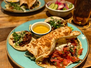 Delicious assortment of tacos and burrito on a vibrant blue plate for a tasty meal
