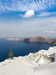 Fototapeta premium White architecture in Santorini island, Greece. Blue sky with white clouds at sunny day.