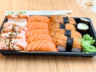 Assorted sushi platter with salmon nigiri inari and maki rolls ready to eat