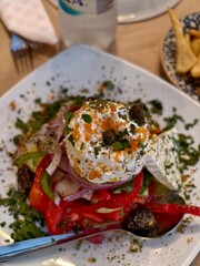 Fresh greek salad with feta cheese tomatoes and olives ready to eat closeup