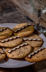 Cookies with chocolate bars on a plate near a glass for dessert photography
