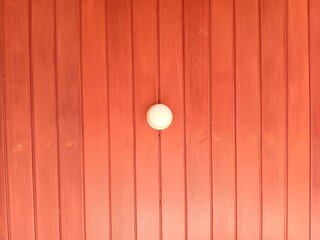 Abstract texture of wooden vertical paneling ceiling background with white bulb lamp on the center. 