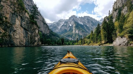 Exploring a serene lake surrounded by mountains in a kayak on a clear day