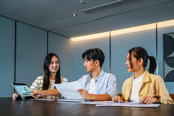 Group of asian motivated professionals engages in a strategic meeting, discussing business growth...