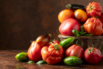 Different varieties of tomatoes on a brown background.