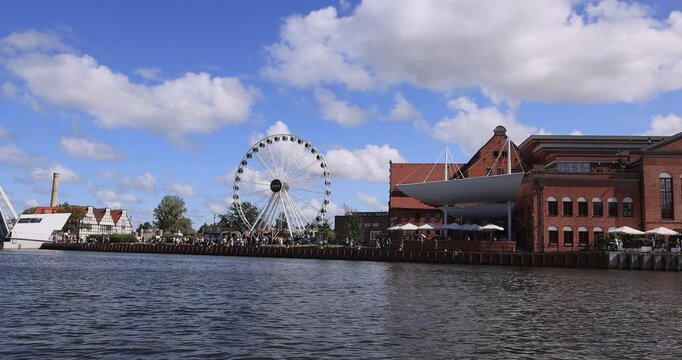 Gdansk Poland water front ferris wheel city sign 4K. Baltic coast northern Poland. World War II started here German invasion. Economic international port. Historical buildings, tourist attractions.