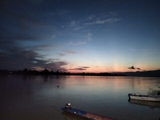 Naklejka premium sunset over the river