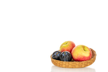 Juicy organic apples and black plums isolated on white background, macro.
