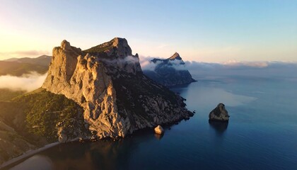 Dramatic coastal sunrise over rugged mountains and sea