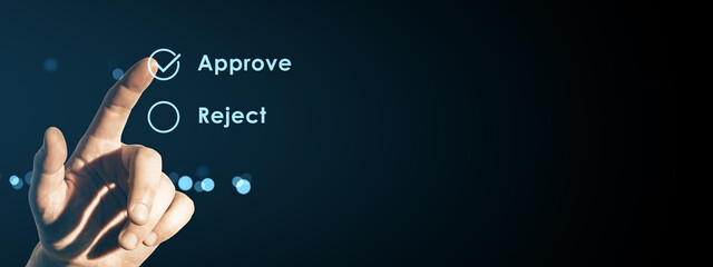 Human finger pressing virtual approve button on digital interface screen with reject option on dark...