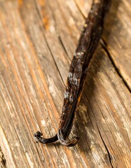 Single Vanilla Bean on Wooden Surface