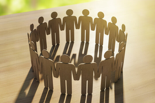 Wooden human figures holding hands in a circle symbolizing unity and support on a wooden surface under warm sunlight with soft background. 3D Rendering