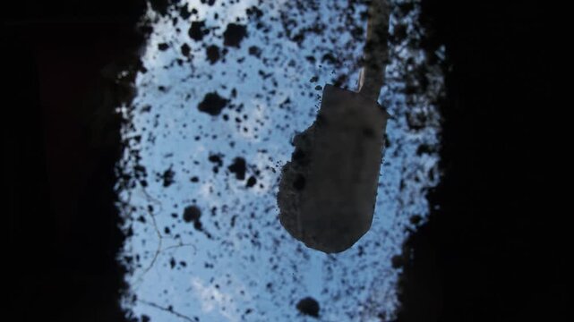Farmer on summer day fills hole with freshly dug earth using shovel. He fertilizes and digs ground before planting trees and plants. Low angle. POV. Vertical. Below