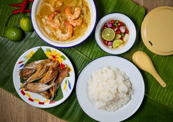 Traditional Thai food set Rice with fried  fish with hot and sour curry , thai style chili sauce, top view food table	
