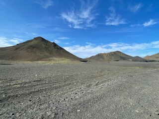 Volcanic Mountains and Barren Landscape in Iceland Under Blue Sky