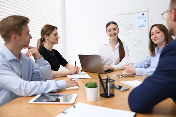 Fototapeta premium Business coach giving presentation to group of people in office
