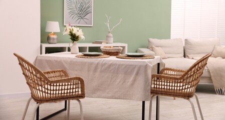 Stylish table with chairs and decor in dining room. Interior design