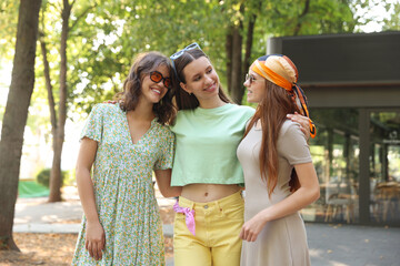 Portrait of happy friends with sunglasses outdoors