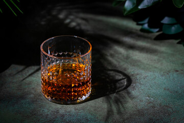 Japanese blended whiskey in glass. Dusk green background, elegant night decoration