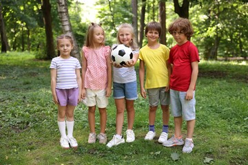Fototapeta premium Cute little kids with soccer ball in park