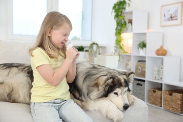 Girl suffering from allergy with her dog at home