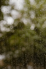 Raindrops on glass with bokeh background