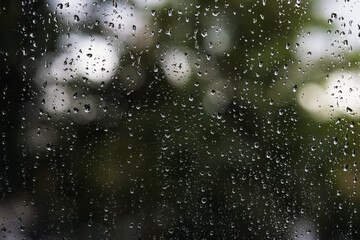 Rainy day with raindrops on window glass