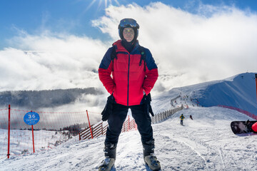 A skier descends the slope with a cable car in the background