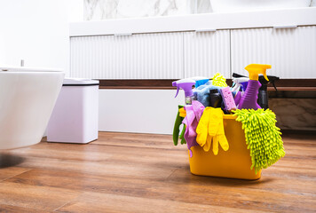 Household chemicals, cleaning products, bottles and sprays,, gloves in orange bucket for antiseptic...