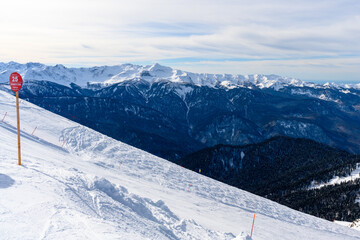 Winter mountain landscape with views of ski trails and forest.