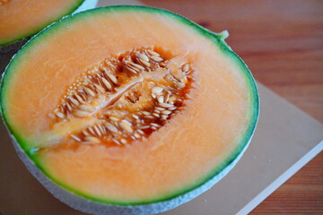 Close-Up of Juicy Cantaloupe Melon Slice Showing Orange Pulp and Seeds, Fresh Summer Seasonal Fruit for Healthy Eating Concept