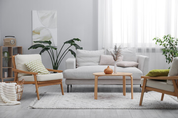 Comfortable armchairs and other furniture in living room. Interior design