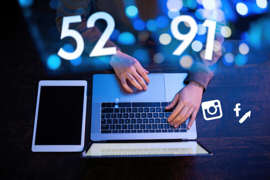 Social Media Engagement and Analytics Person Using Laptop with Overlay of Numbers, Social Media Icons, and Data Visualization Representing Online Marketing and Digital Strategy - Powered by Adobe