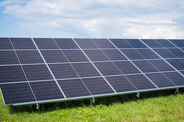 Solar photovoltaic panels rows on green grass field. Sustainable alternative energy source power...