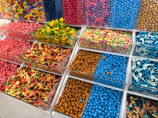 A colorful and inviting candy shop filled with jars, shelves, and displays of sweets, lollipops, and chocolates. A cheerful atmosphere that evokes childhood joy, indulgence, and festive celebration