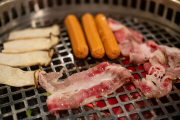 Sliced brisket on the  grill. BBQ rare meat with soft focus